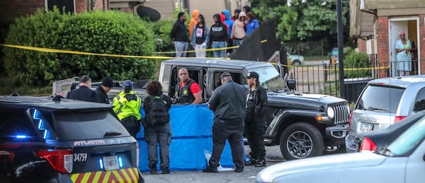Atlanta police investigate after the body of a shooting victim was found in May at Forest Cove Apartments. Another person was wounded in the shooting. Since 2009, 19 homicides have occurred at Forest Cove, and a judge has ordered that the complex be demolished. (John Spink / John.Spink@ajc.com)